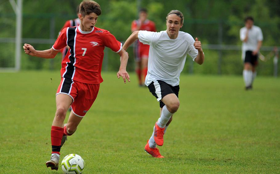 AOSR's Luca Baldestein takes the ball upfield followed by AFNORTH's Hans-Andres Haller in a Division II semifinal in Reichenbach, Wednesday, May 22, 2019. AOSR won the game 1-0 to advance to Thursday's final against Aviano.