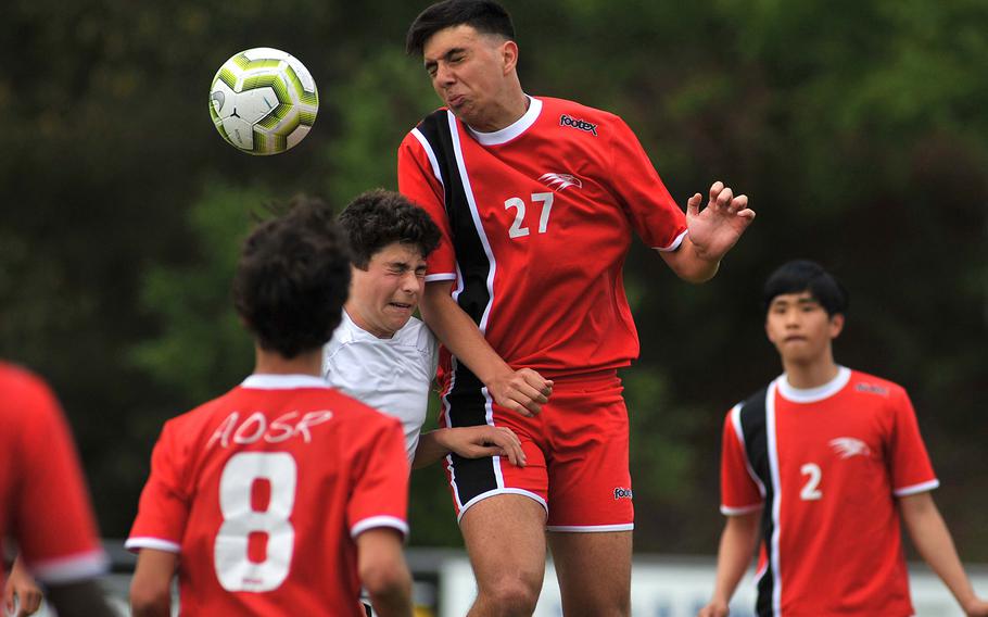 AOSR's Giuseppe Amara gets the header against AFNORTH's Preston Guza in a Division II semifinal in Reichenbach, Wednesday, May 22, 2019. AOSR won the game 1-0 to advance to Thursday's final against Aviano. AOSR's Guglielmo Fradusco, left, and Seung Hyun Na watch the action.