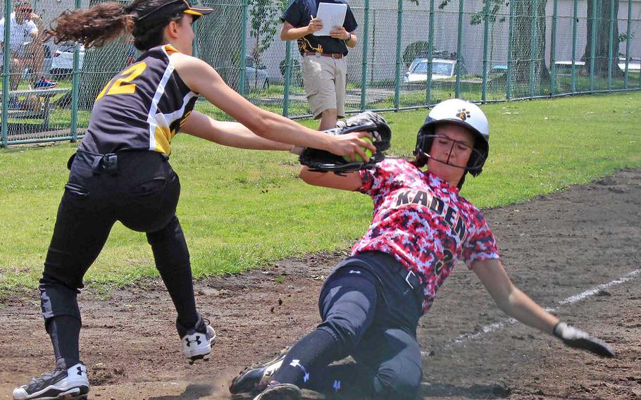 Kadena's Keely Albrecht tries to slide past the tag of American School In Japan's Sasha Sasanuma. Albrecht got the win and the Panthers edged the Mustangs 10-9 during Wednesday round-robin play in the Far East Division I Softball Tournament.