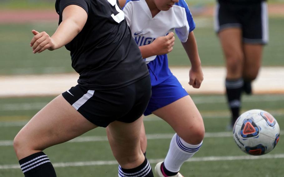 Christian Academy Japan's Akina Shimamoto and Daegu's Lisa Lyons battle for the ball during Wednesday's pool play in the Far East Division II girls soccer tournament. The Knights got their first win of the season 2-0.