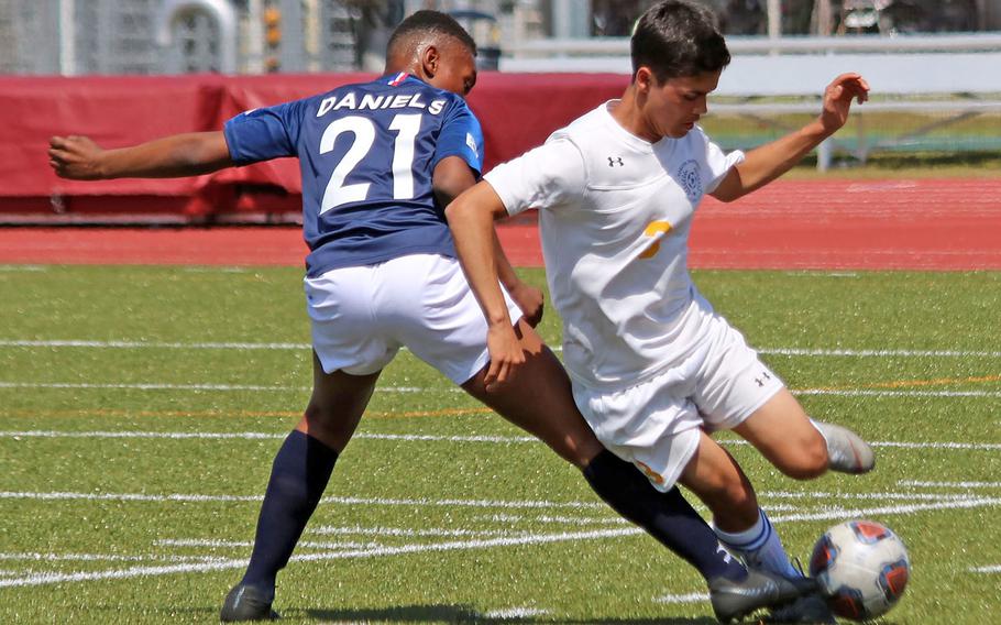 Seoul American' s Jerell Daniels and Yokota's Cisco Rodriguez battle for the ball during Wednesday's Far East Boys Division II soccer tournament pool play. The Panthers won 2-0.