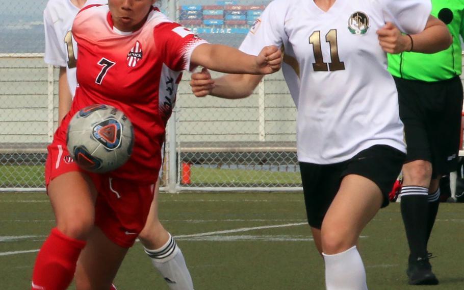 Nile C. Kinnick's Megan Thomas plays the ball against Humphrey's Jacqueline Puskas during Wednesday's Far East Girls Division I soccer tournament round robin. The Red Devils won 4-0.