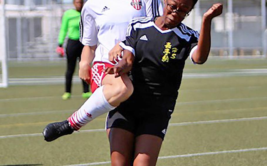 Nile C. Kinnick's Samantha Kenney heads the ball against Kadena's Nyla White during Wednesday's Far East Girls Division I soccer tournament round robin. The Panthers won 2-1, handing the Red Devils their first loss of the season.