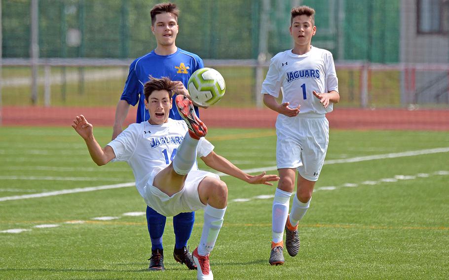 Sigonella's Noah Bachicha clears the ball in front of Ansbach's Nick Benson as teammate Lawrence Caro watches the action in the boys Division III final at the DODEA-Europe soccer championships in Kaiserslautern, Germany, Thursday, May 23, 2019. Ansbach took the title with a 2-1 win.