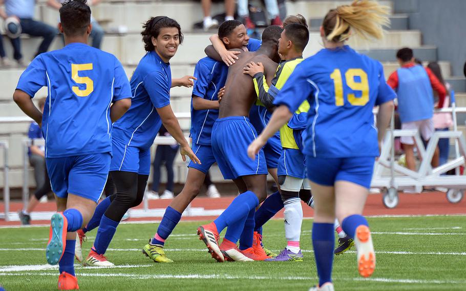 The Ansbach Cougars celebrate their 2-1 win over Sigonella in the boys Division III final at the DODEA-Europe soccer championships in Kaiserslautern, Thursday, May 23, 2019.