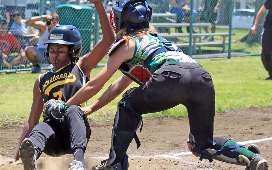 Kubasaki catcher Jocelyn Powell tries to tag American School In Japan baserunner Erin Dowich during Thursday's round robin game in the Far East Division I softball Tournament. The Mustangs won 11-10.