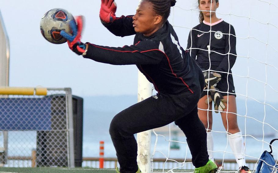 Nile C. Kinnick goalkeeper A'anna Taylor stops an American School In Japan shot during the penalty-kick shootout in Thursday's semifinal match in the Far East Division I girls soccer tournament. The Red Devils dethroned the Mustangs by outshooting ASIJ 3-1 in PKs.