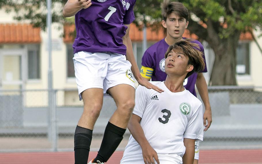 Kadena's Logan Taylor heads the ball against Kubasaki's Kaisei Taylor during Thursday's semifinal match in the Far East Division I boys soccer tournament. The Panthers dethroned the defending champion Dragons 2-1.