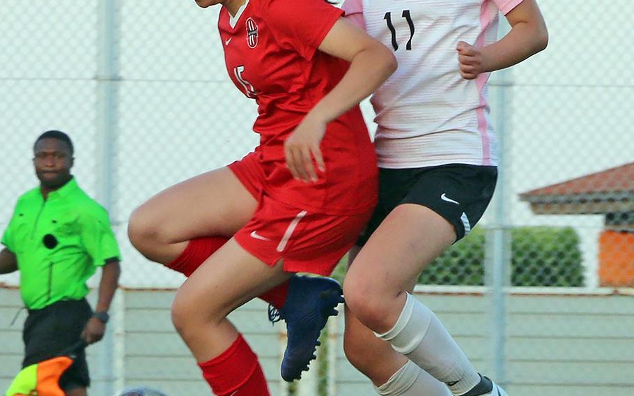 Kinnick's Irie O'Donnell and ASIJ's Shuly Zuo try to settle the ball during Thursday's semifinal in the Far East Division I girls soccer tournament. The Red Devils won in penalties 3-1.
