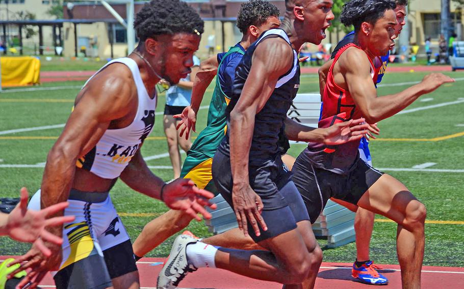 Flanked by Kadena's Eric McCarter and Kinnick's Chris Watson, Humphreys' Tevijon Williams blazes toward the finish in a Pacific record 10.77 seconds during Thursday's 100-meter dash in the Far East track and field meet.