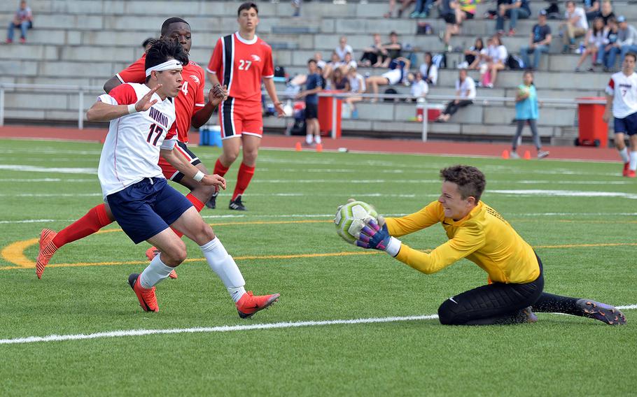 AOSR keeper Martin Jijena beats Aviano's Jason Valladaras to the ball as AOSR's Jalil Saint Juste and Guiseppe Amara watch. AOSR defeated Aviano 4-0 in the boys Division II final at the DODEA-Europe championships in Kaiserslautern on Thursday, May 23, 2019. 
