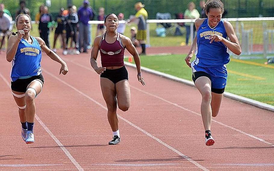 Wiesbaden's Isabella Pizarro, right, races her teammate Whitney Bivins to the finish line to win the girls 100-meter dash title at the DODEA-Europe track and field finals in 12.52 seconds to Bivins 12.53. At center is Vilseck's Dionne Mayfield, who finished fifth. Pizarro also won the triple jump with a 33 feet, 9 inch leap.