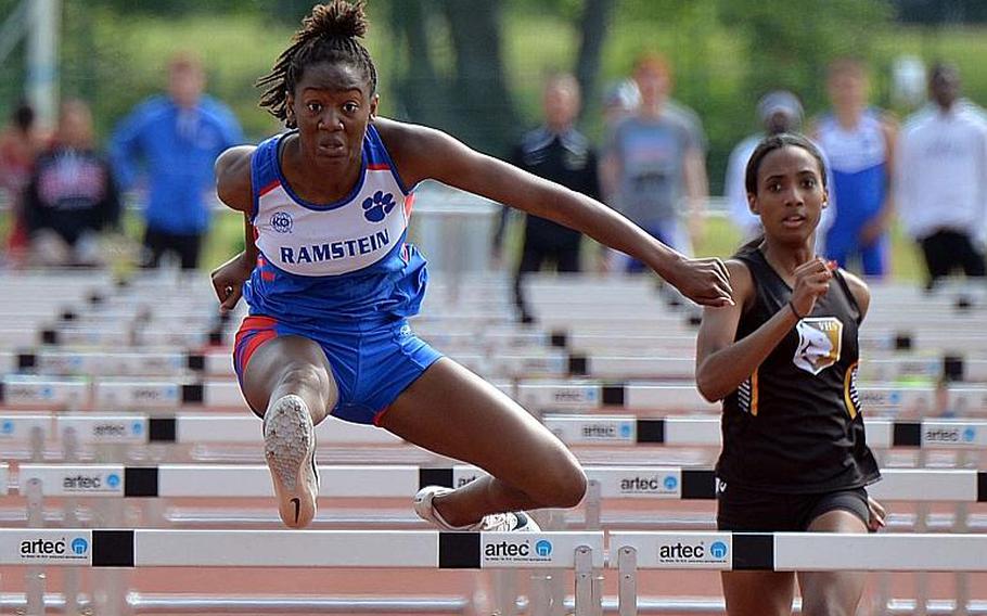 Ramstein's Jaya Worthington clears the next to last hurdle on her way to winning the girls 100-meter hurdles in 16.07 seconds at the DODEA-Europe track and field finals in Kaiserslautern, Saturday, May 25, 2019. At right is Vicenza's Ivani Turner, who finished third.