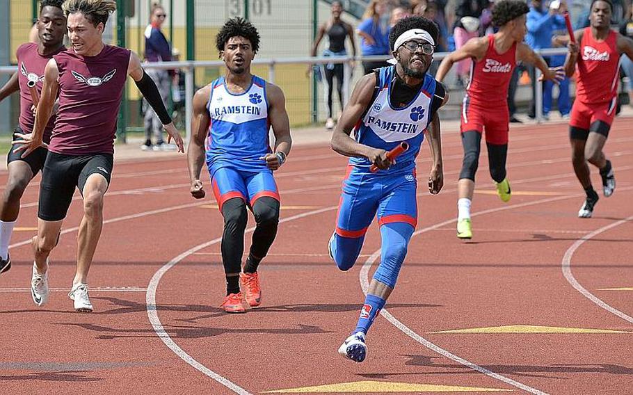 Ramstein's Cameron Chester sprints off after taking the baton from Dominique Arizpe in the boys 4x100-meter relay at the DODEA-Europe track and field finals in Kaiserslautern, Saturday, May 25, 2019. Along with teammates Isaiah Allen and Jason Jones Jr. they took the title in 43.71 seconds.