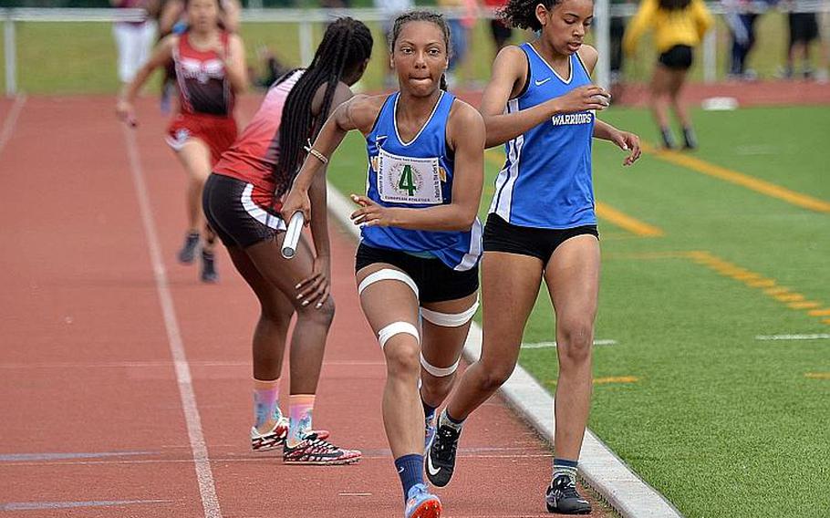Wiesbaden's Whitney Bivins spurts off on the last leg of the 4x400-meter relay after taking the baton form Catianna Binyard-Turner. The duo along with teammates Myriam Friel and Ashanti Scott won the race in 4 minutes, 10.59 seconds at the DODEA-Europe track and field finals in Kaiserslautern, Saturday, May 25, 2019.