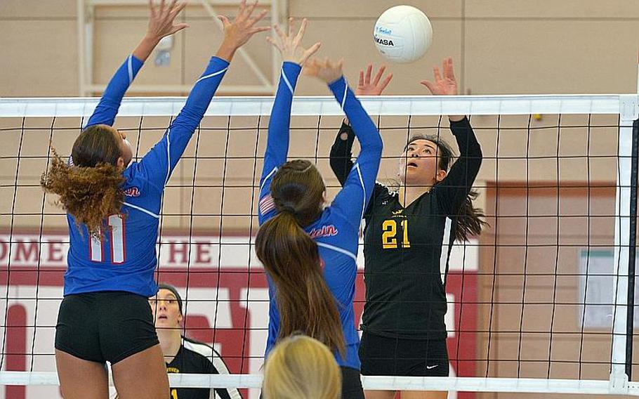 Stuttgart's Karen Kosinski lobs the ball over the Ramstein defense of Masaya Archbold, left, and Ahmarie Young in the Division I final at the DODEA-Europe volleyball championships in Kaiserslautern, Germany. Stuttgart took the title with a 25-23, 25-18, 25-10 win over Ramstein.