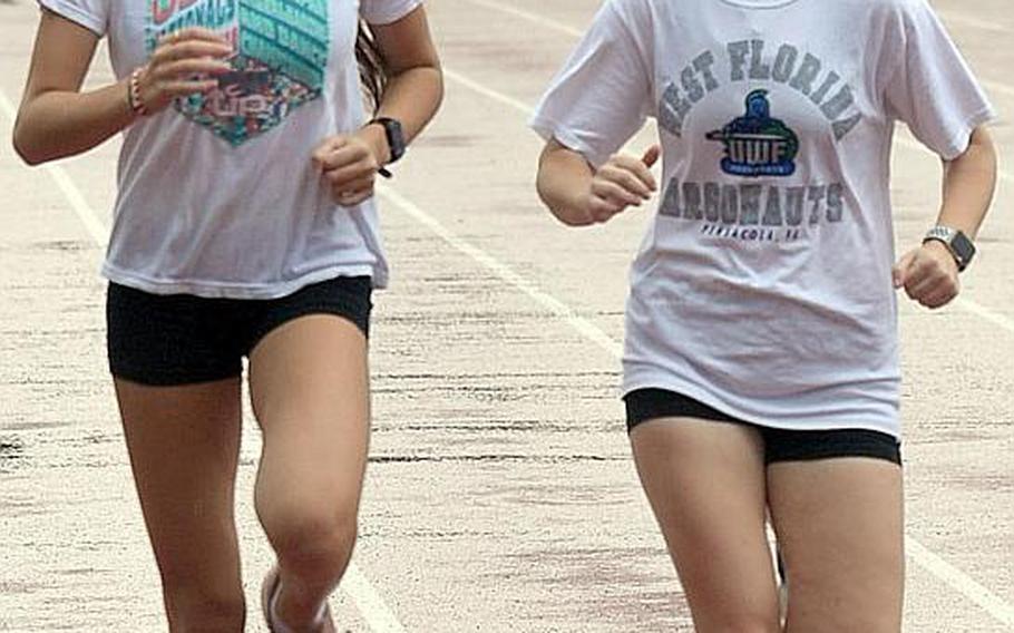 Sophomore Aiko Galvin, left, and senior Emily Swain finished 2-3 for defending Division II champion Yokota in the 2018 Far East cross country meet.