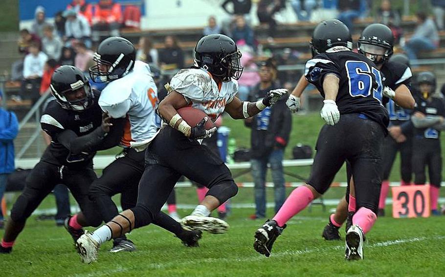 Spangdahlem's Deon Montgomery runs the ball towards the end zone as several Hohenfels Tigers try to stop him, during a game at Hohenfels, Germany, Saturday, Oct. 26, 2019. 