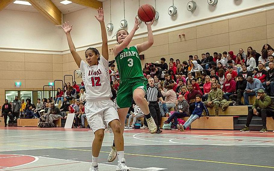 SHAPE's Gabi Shultz takes a shot during a basketball game between SHAPE and Kaiserslautern at Kaiserslautern High School, Germany, Friday, Dec. 6, 2019. SHAPE won the game 45-40.