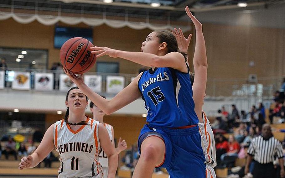 June Smith of Hohenfels gets past Emerson Retka to go to the basket as Izzy Smith watches the action in the girls Division III final at the DODEA-Europe basketball championships in Wiesbaden, Germany, Saturday, Feb. 22, 2020. Spangdalem took the title with a 37-21 win.