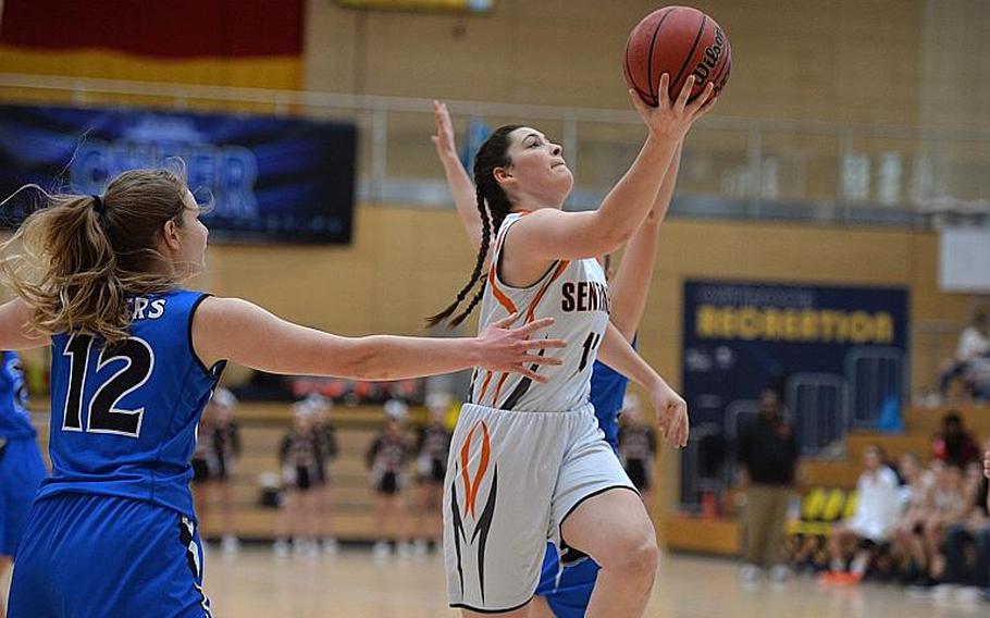 Izzy Smith of Spangdahlem goes in for a shot between Tiana Rodgers and June Smith  in the girls Division III final at the DODEA-Europe basketball championships in Wiesbaden, Germany, Saturday, Feb. 22, 2020. Spangdahlem won 37-21.