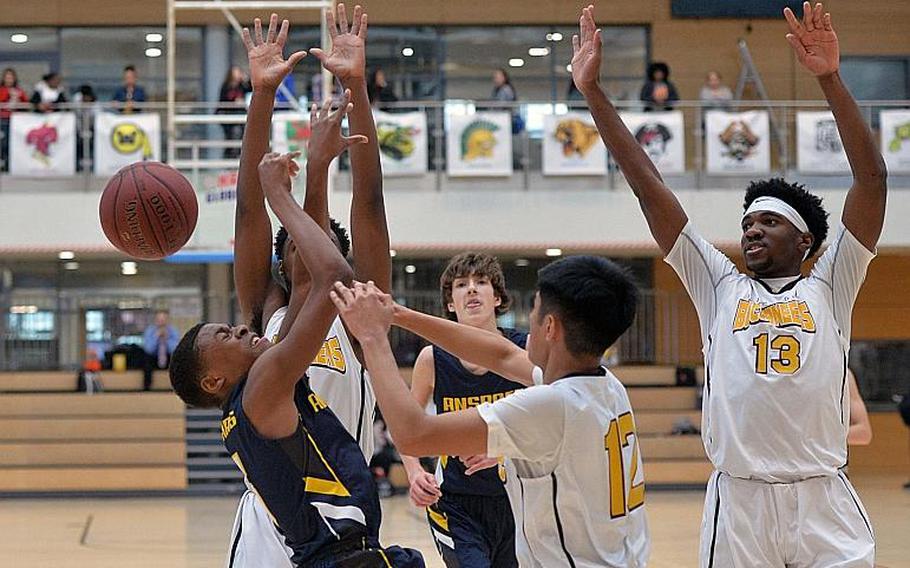 Josiah Quinland of Ansbach is stopped by a Baumholder foul as he goes to the basket in the boys Division III championship game at the DODEA-Europe basketball finals in Wiesbaden, Germany, Saturday, Feb. 22, 2020. Baumholder won its third title in a row with a 50-43 win.