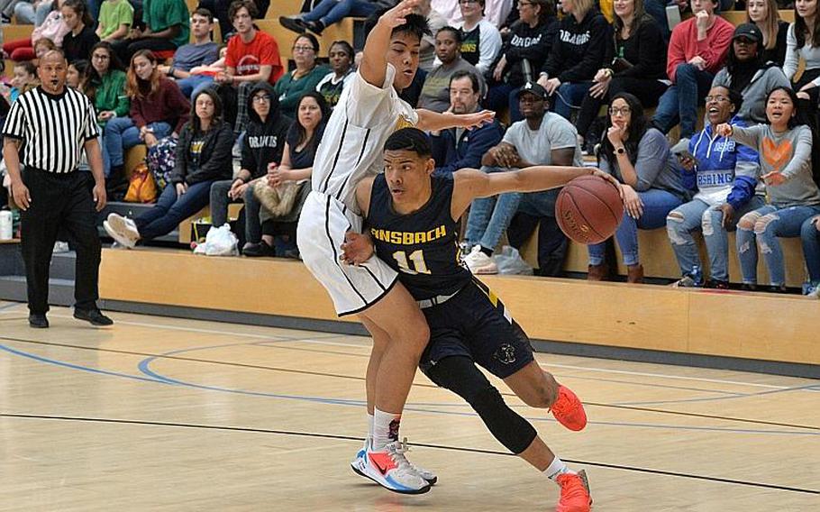 Shane Nesbitt of Ansbach drives to the basket against Isaiah Daep of Baumholder in the boys Division III championship game at the DODEA-Europe basketball finals in Wiesbaden, Germany, Saturday, Feb. 22, 2020. Baumholder won its third title in a row with a 50-43 win.