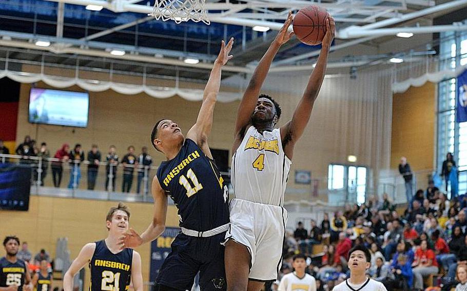 Laurence Huxtable of Baumholder scores over Shane Nesbitt of Ansbach in the boys Division III championship game at the DODEA-Europe basketball finals in Wiesbaden, Germany, Saturday, Feb. 22, 2020. Baumholder won its third title in a row with a 50-43 win.
