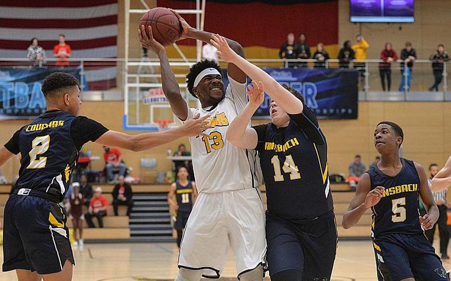 Chandler Pigge of Baumholder fights his way to the basket against Dustin Martin of Ansbach, as Brendon Henderson, left, and Josiah Quinland watch. Baumholder won its third title in a row with a 50-43 win in the boys Division III championship game at the DODEA-Europe basketball finals in Wiesbaden, Germany, Saturday, Feb. 22, 2020.