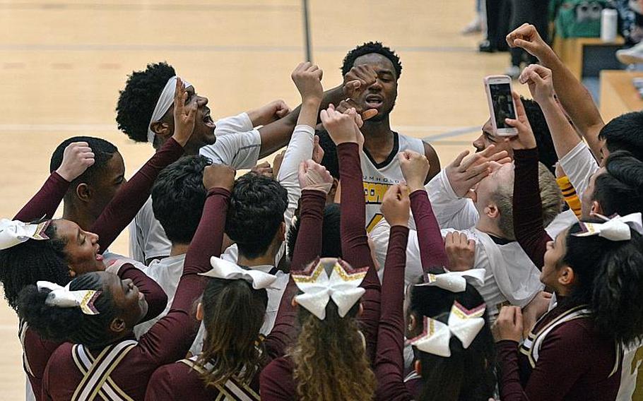 The Baumholder Buccaneers players and cheerleaders celebrate their third Division III title in a row after defeating Ansbach 52-31 at the DODEA-Europe basketball finals in Wiesbaden, Germany, Saturday, Feb. 22, 2020.