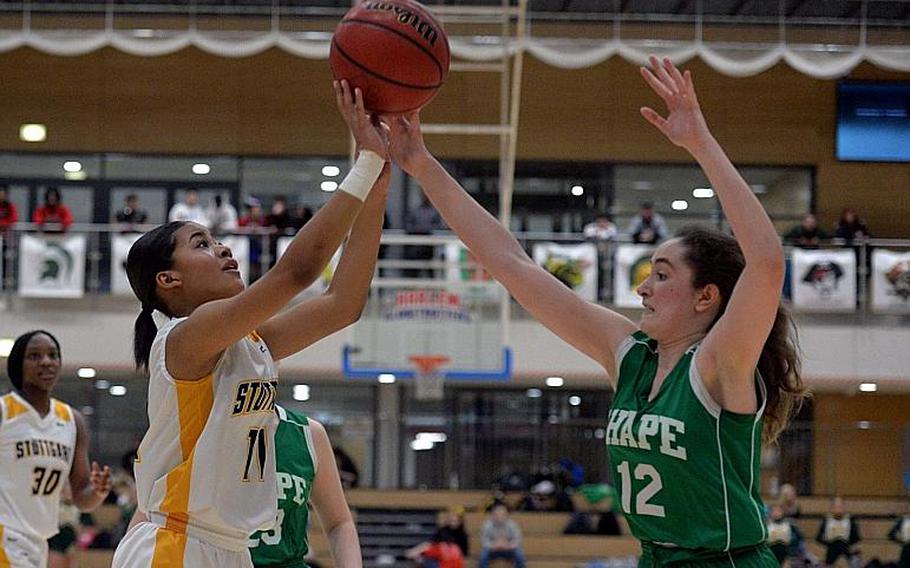 Victoria Antoine of Stuttgart shoots as Claudia Commi defends in the girls Division I final at the DODEA-Europe basketball championships in Wiesbaden, Germany, Saturday, Feb. 22, 2020.