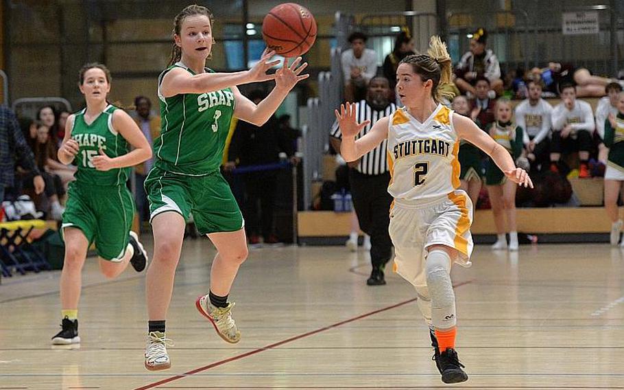 Gabi Schultz of SHAPE passes to a teammate as she takes the ball up the court, guarded by Olivia Sullens of Stuttgart in the girls Division I final at the DODEA-Europe basketball championships in Wiesbaden, Germany, Saturday, Feb. 22, 2020.