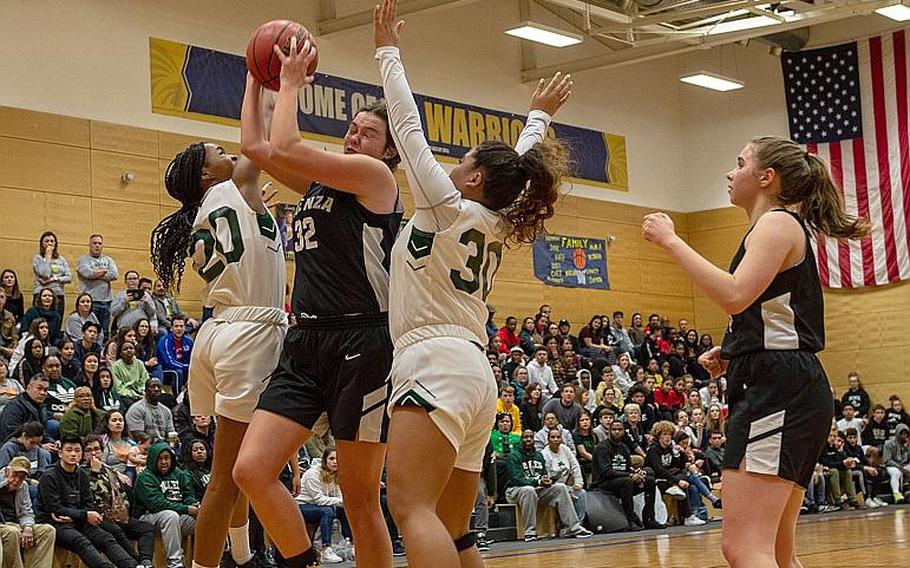 Players from Naples and Vicenza fight for a rebound during the DODEA-Europe 2020 Division II Girls Basketball Championship game at the Wiesbaden High School, Germany, Saturday, Feb. 22, 2020. Naples won the game 44-35.