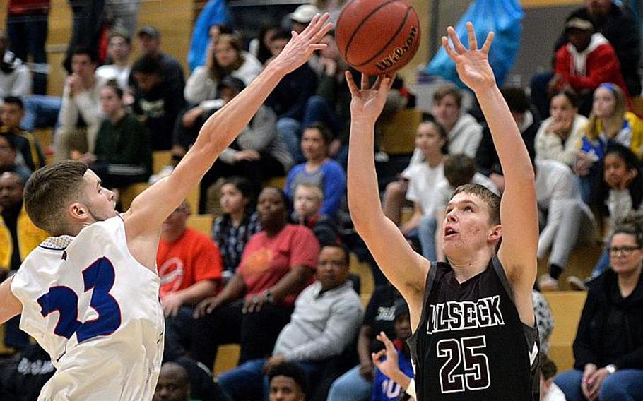 Ryan Heckert of Vilseck attempts a three-pointer over Luis Figueroa in the boys Division I final at the DODEA-Europe basketball championships in Wiesbaden, Germany, Saturday, Feb. 22, 2020. Vilseck took the title with a 56-42 win.