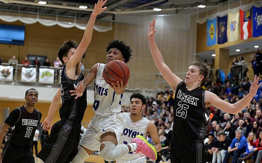 Jerod Little of Ramstein scores against Vilseck defenders Sean Bergosh, left, and Ryan Heckert in the boys Division I final at the DODEA-Europe basketball championships in Wiesbaden, Germany, Saturday, Feb. 22, 2020. Vilseck took the title with a 56-42 win.