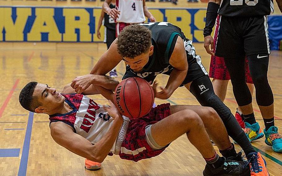 Naples' Kieth Rascoe and Aviano's Gabriel Hodgson fight over a lose ball during the DODEA-Europe 2020 Division II Boys Basketball Championship game at Wiesbaden High School, Germany, Saturday, Feb. 22, 2020. Naples won the game 40-35.