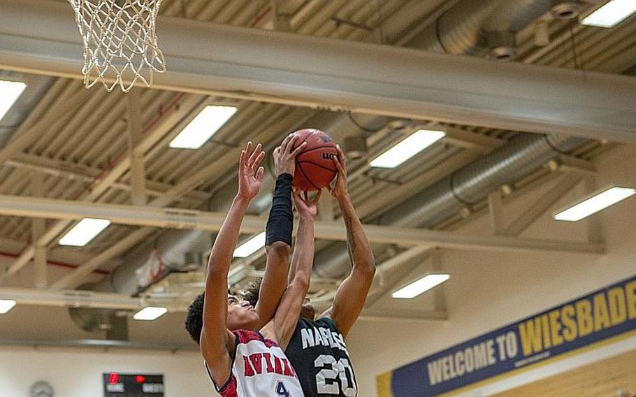 Players from Naples and Aviano fight over a rebound during the DODEA-Europe 2020 Division II Boys Basketball Championship game at Wiesbaden High School, Germany, Saturday, Feb. 22, 2020. Naples won the game 40-35.