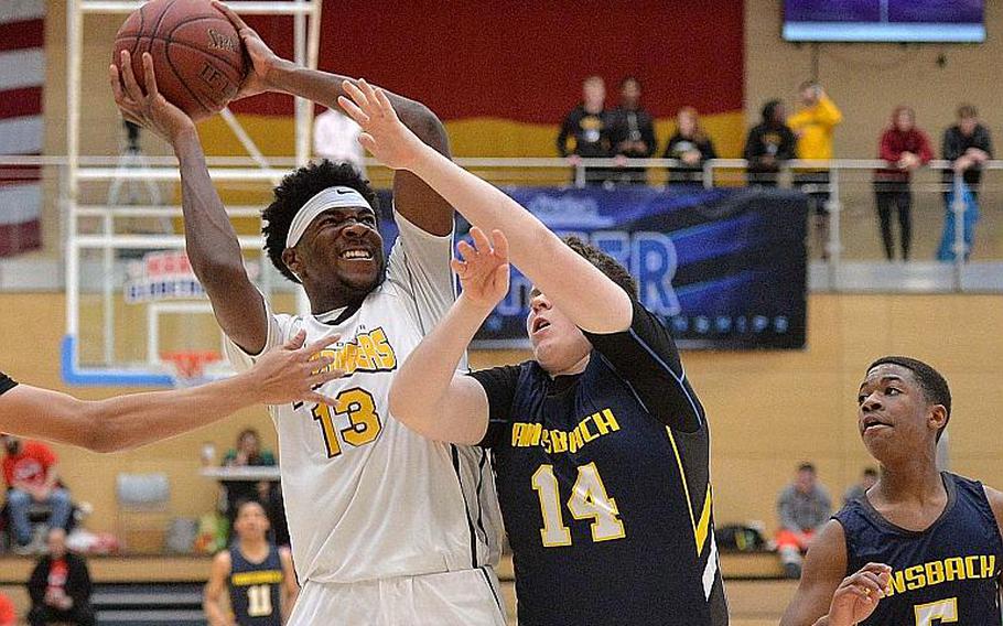 Chandler Pigge of Baumholder fights his way to the basket against Dustin Martin of Ansbach, as Josiah Quinland watches. Baumholder won their third title in a row with a 50-43 win in the boys Division III championship game at the DODEA-Europe basketball finals in Wiesbaden, Germany, Saturday, Feb. 22, 2020.