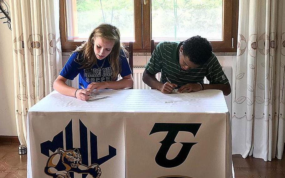 Aviano High School seniors Danielle Kandle, left, and Donavin Robinson sign letters of intent to play NCAA sports at a ceremony in May 2020. Kandle will play girls soccer at Mars Hill University in North Carolina, while Robinson will compete in track and field at Tiffin University in Ohio.