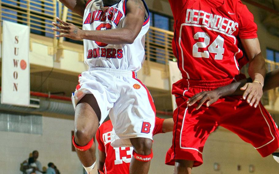 Buck Buchanan (6) of Guam's Andersen Bombers drives for a shot against Larturo Washington McMahan (24) of South Korea's Osan Defenders during Sunday's double-elimination championship bracket playoff game.