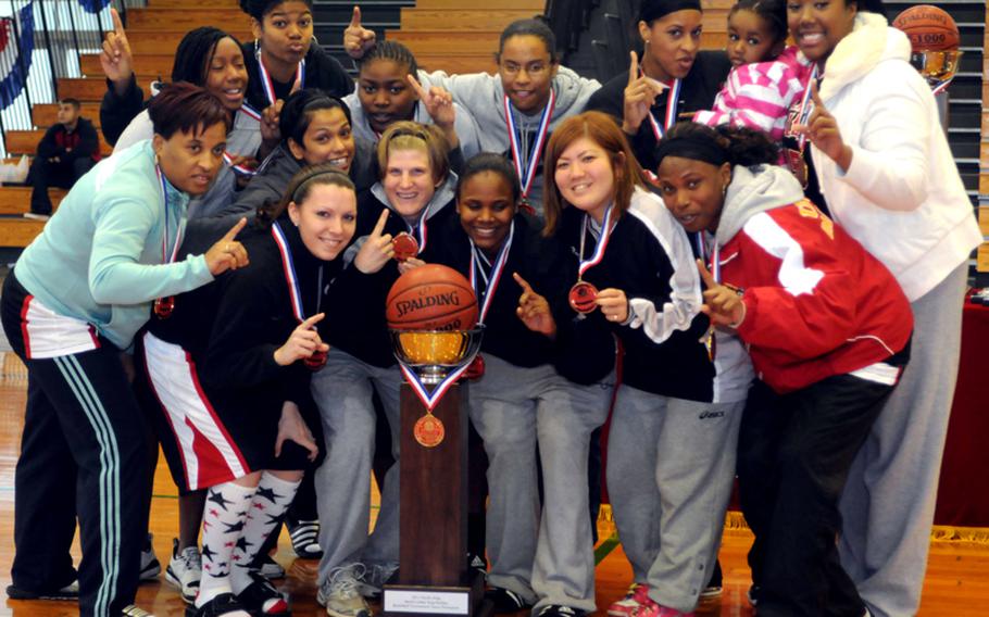Members of Lady Ballaz celebrate with their team championship trophy.