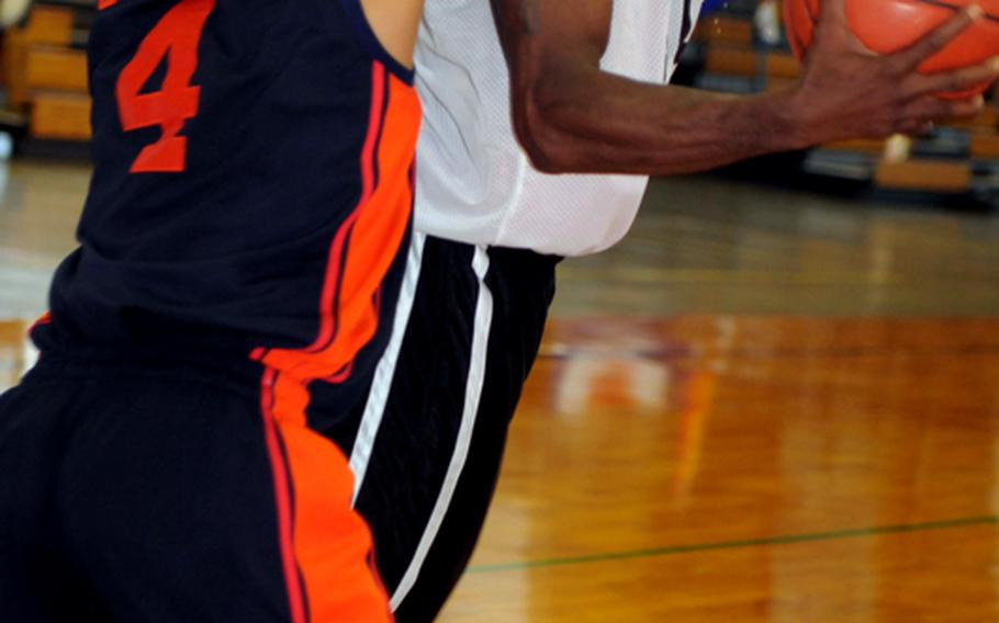 Robert Smith (10) of Team of Champions goes up for a shot against James Wilson of Kadena Air Base.