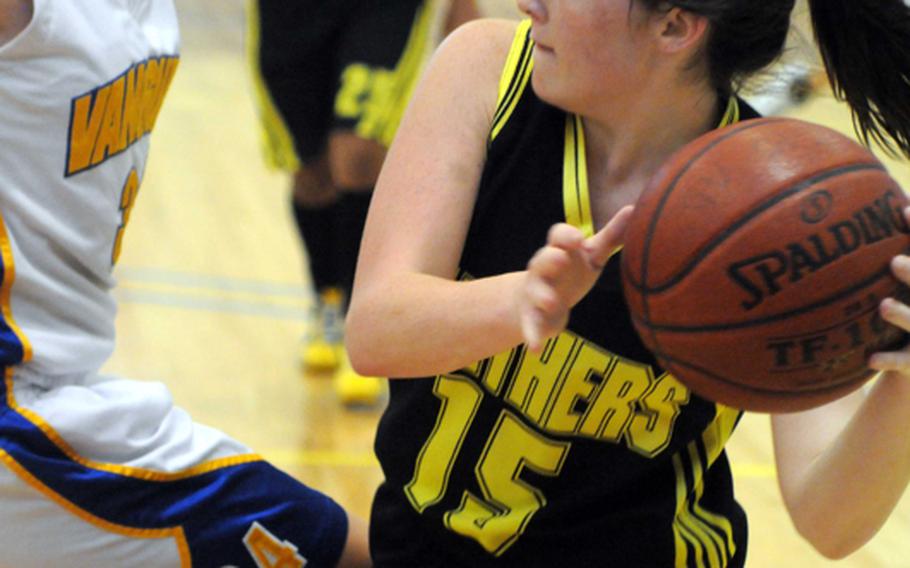 Kadena's Desirae Seals looks to pass around Kendra Hause of Faith Academy during Friday's semifinal game in the Far East High School Girls Division I Basketball Tournament at Charles King Fitness & Sports Center, Naval Base Guam. Faith reached its third straight final by beating Kadena, 48-35.