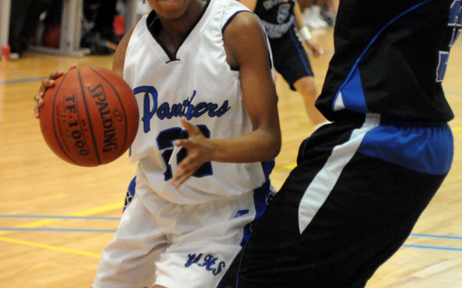 Yokota's Trinity Davis tries to drive around Mecca Perkins of Seoul American during Friday's semifinal game in the Far East High School Girls Division I Basketball Tournament at Charles King Fitness & Sports Center, Naval Base Guam. Seoul American reached its sixth final in seven years by beating Yokota, 65-45.