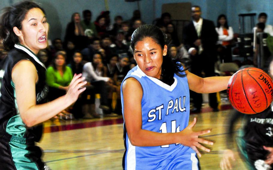 Jaymee Cruz of St. John's dribbles past Daegu American's Angie Robinet to the basket during Friday's championship game in the Far East High School Girls Division II Basketball Tournament at Kelly Fitness & Sports Center, Camp Walker, South Korea. Daegu beat St. Paul in the first of two championship games, 47-37. St. Paul repaid the favor in a rematch and won its first D-II title, 49-25.