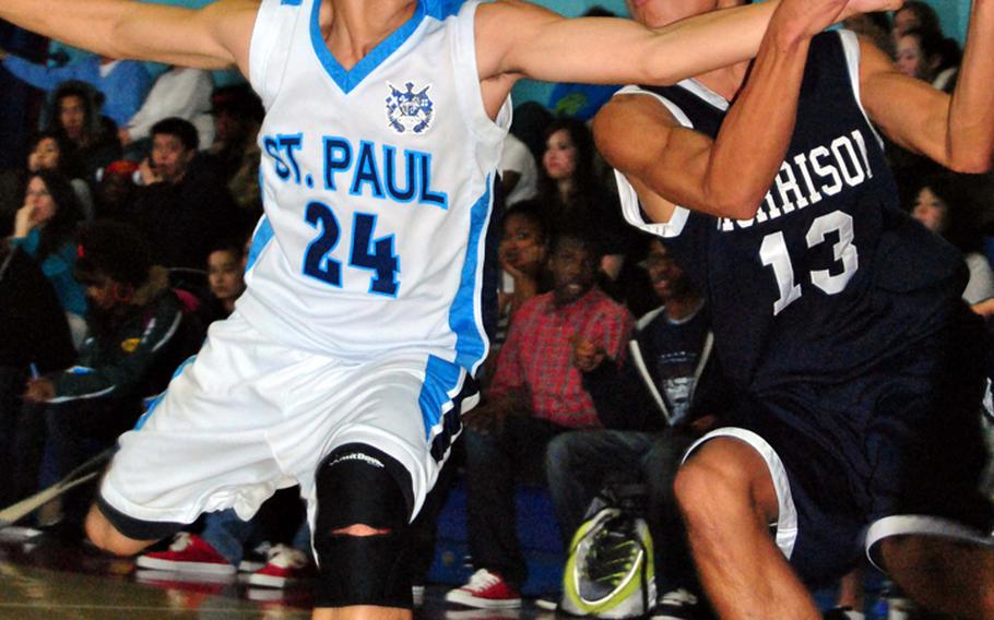 Morrison Academy's Jordan Heading (13) fights for control of the ball as St. Paul Christian's Kory Borja defends during Friday's championship game in the Far East High School Boys Division II Basketball Tournament at Kelly Fitness & Sports Center, Camp Walker, South Korea. Morrison captured its third straight title and fifth overall by beating St. Paul, 63-32.