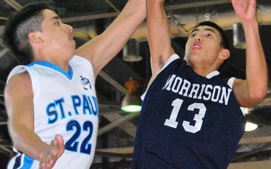 Morrison Academy's Jordan Heading puts up a shot over Pierson Cruz of St. Paul Christian during Friday's championship game in the Far East High School Boys Division II Basketball Tournament at Kelly Fitness & Sports Center, Camp Walker, South Korea. Morrison captured its third straight title and fifth overall by beating St. Paul, 63-32.