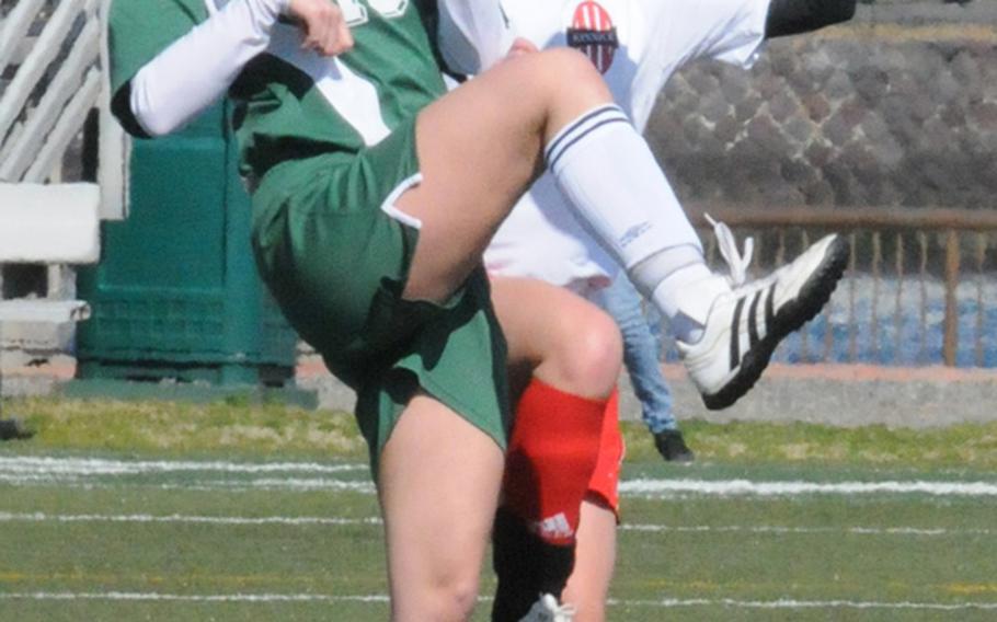 Robert D. Edgren's Chloe Youtsey (13) and Nile C. Kinnick's Audrey Parker battle for the ball during Saturday's soccer match at Yokosuka Naval Base, Japan. The host Red Devils routed the Eagles 7-1 in the season opener for both teams.