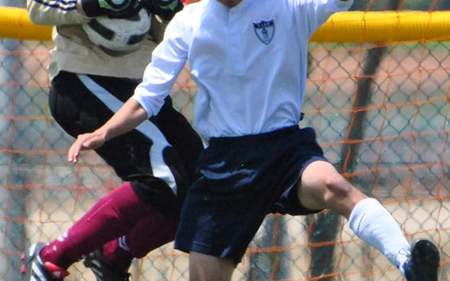 Matthew C. Perry Samurai goalkeeper Hayden Miller snags a shot in front of Yeram Byun of Yongsan International-Seoul during Monday's pool-play match in the 2011 Far East High School Boys Division II Soccer Tournament at Camp Humphreys, South Korea.