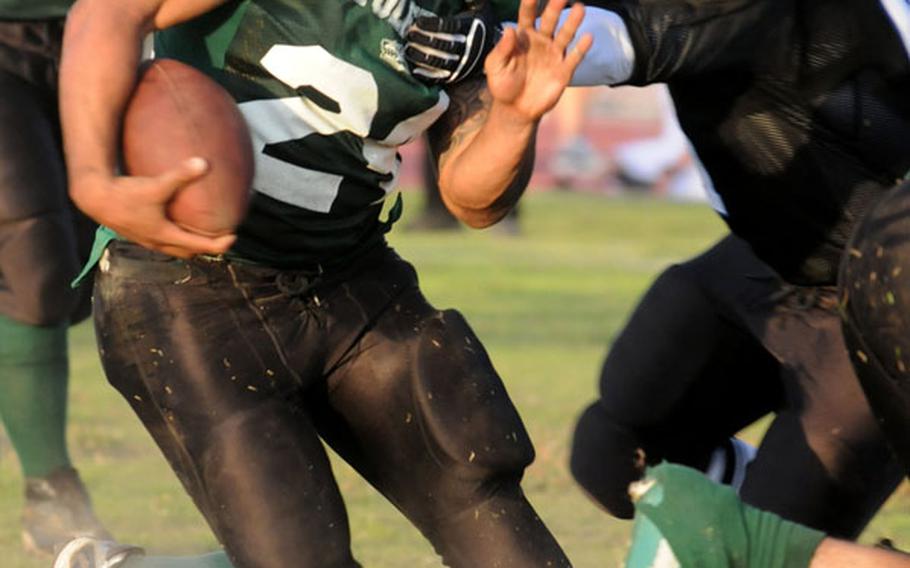 Joint Task Force Wolf Pack running back Enrique Menendez looks for running room against the Kadena Dragons defense.